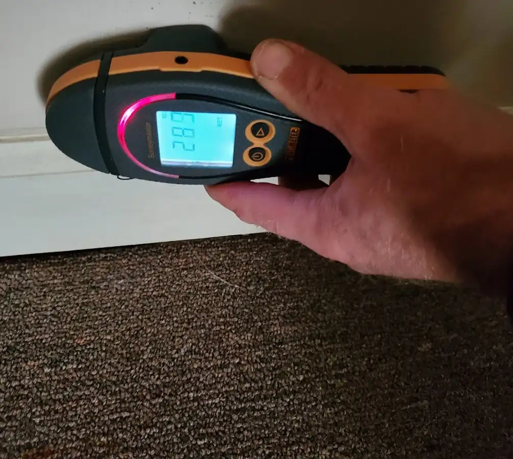 Moisture detection at baseboard during Storm Damage Restoration in East Peoria